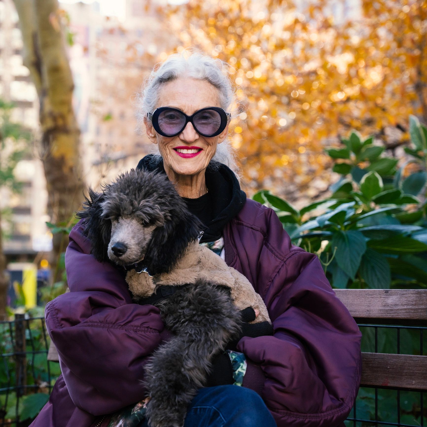 Happy senior woman posing with her dog
