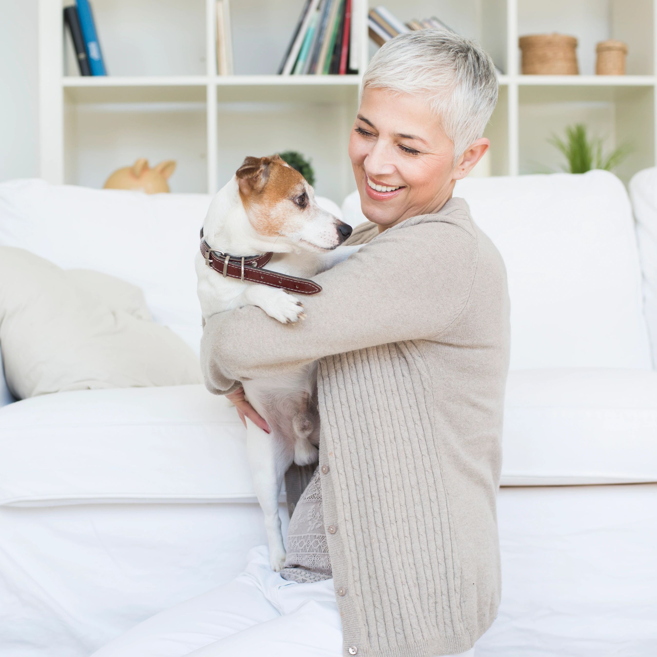 Cheerful mature woman with her pet at home